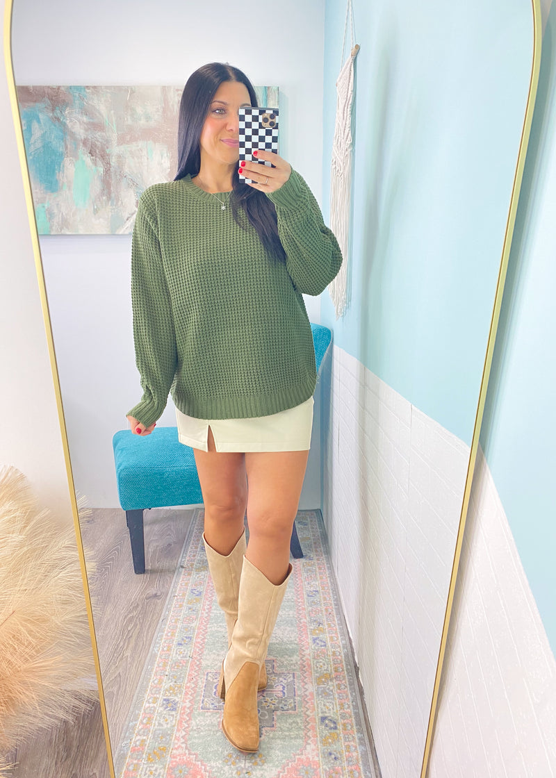 *DOORBUSTER* 'Wendi' Olive Green Waffle Knit Round Neck Sweater-This waffle knit sweater is a must have classic silhouette! The split hem makes it easy to tuck in but also looks cute untucked with the rounded bottom hem. Dress this sweater up with skirts or jeans and boots and layered jewelry or you can wear it super casual with jeans and sneakers. -Cali Moon Boutique, Plainville Connecticut