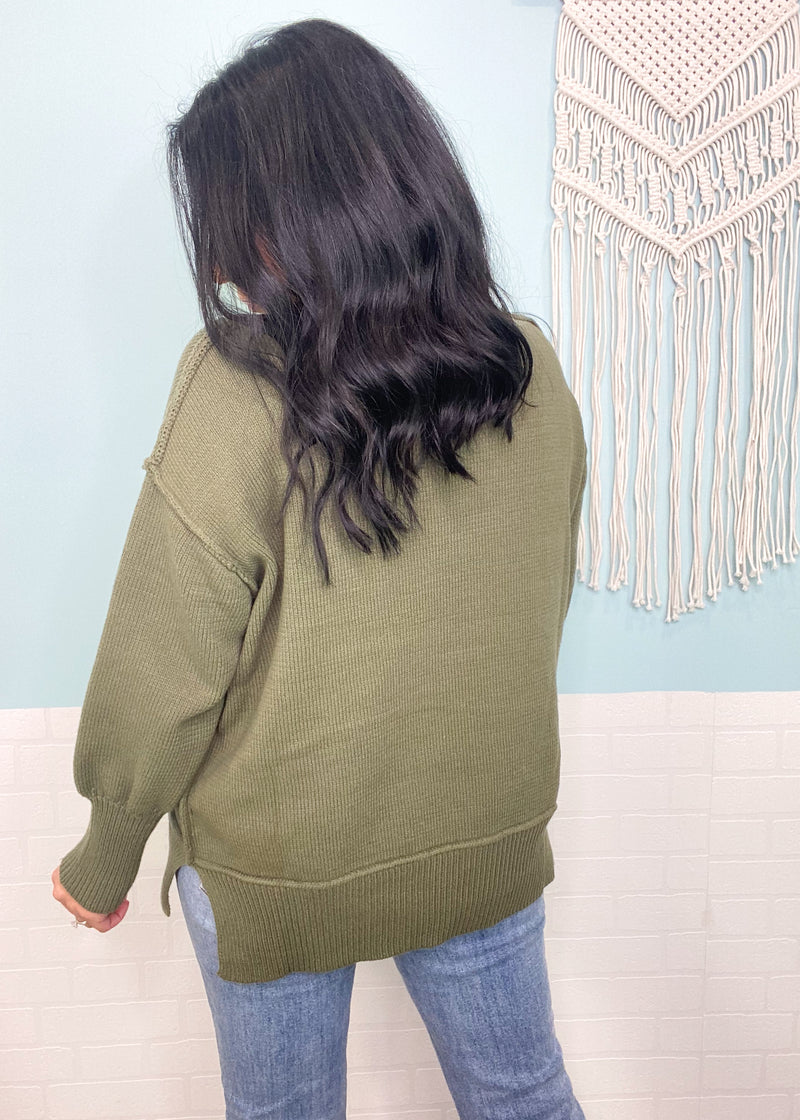 'Stevie' Olive Split Side Slouchy Sweater-This olive green sweater has a perfectly slouchy silhouette perfect for jeans and leggings! The neutral color can be paired with other neutrals and some pops of color like pinks & yellow.

-Cali Moon Boutique, Plainville Connecticut