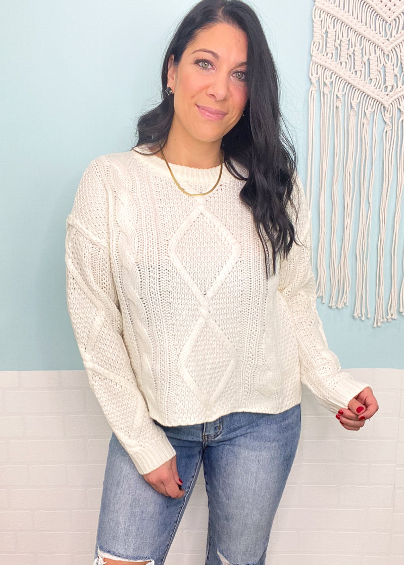 'Timeless' Ivory Cable Knit Notch Hem Sweater-A cable knit is a classic for all time! This cozy sweater has a shorter length with a notch hemline making it perfect to tuck in or wear untucked to show off the cute hem! Matches with all shades of denim and colored bottoms!-Cali Moon Boutique, Plainville Connecticut