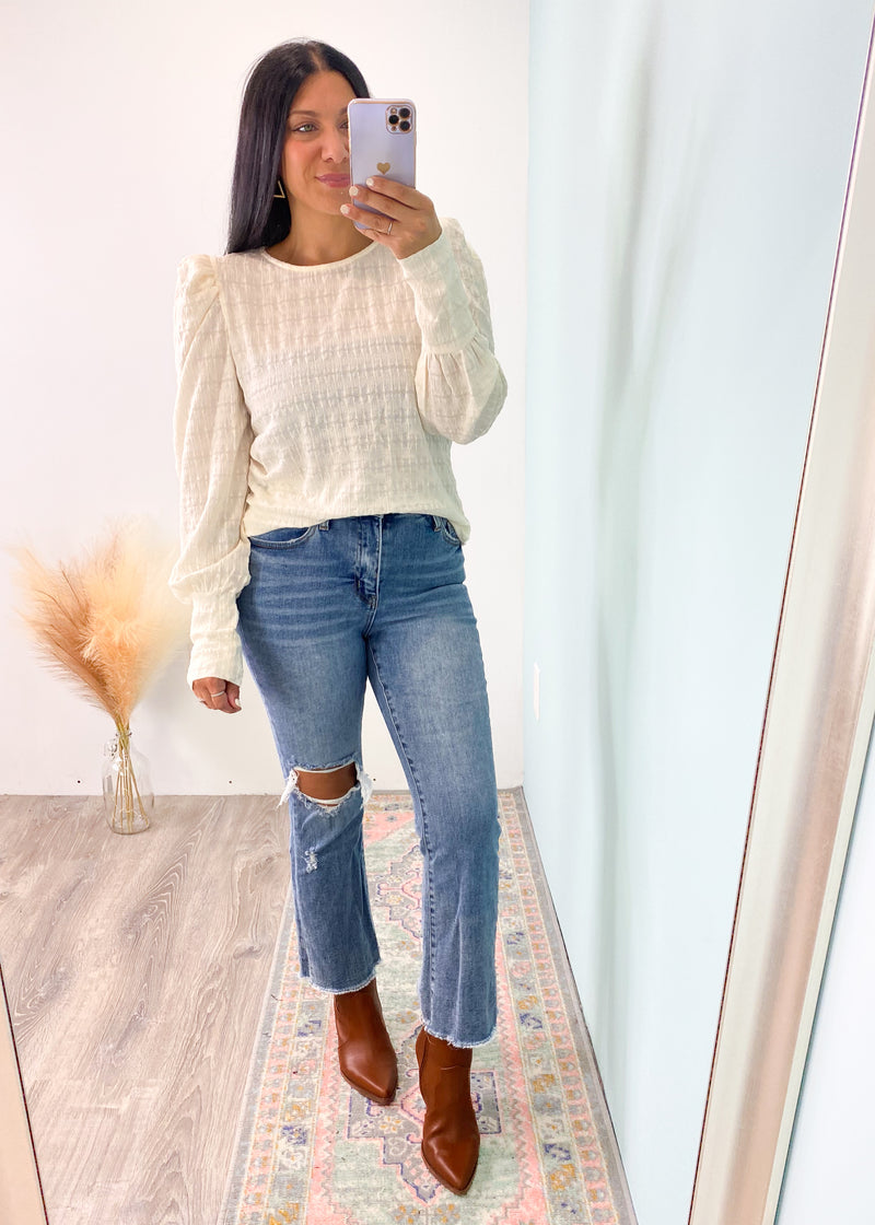 'On the Agenda' Ivory Textured Puff Sleeve Top-For this top, it's all in the details! Textured & ruched fabric, puff shoulders and longline fitted cuffs. Tuck this in to show off the shoulder details or wear it untucked with the texture details doing all the work! Relaxed & comfy fit for all day wear.-Cali Moon Boutique, Plainville Connecticut