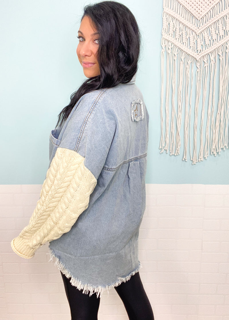 'This & That' Denim Shacket with Cable Sweater Sleeves-This shacket is the best of both worlds! A light wash denim body with cozy ivory cableknit sleeves. This neutral color combo will pair with other shades of denim, leggings and colored denim. A must have that will carry you through multiple seasons.-Cali Moon Boutique, Plainville Connecticut