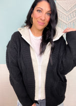 'Dream Team' Black Sweater Jacket with Attached Knit Hood-We can't think of a better cozy combination than this sweater jacket! The black diamond cable knit sweater paired with heather gray knit insert & hood is a dream! A classic color combo that you can wear with any bottoms! -Cali Moon Boutique, Plainville Connecticut