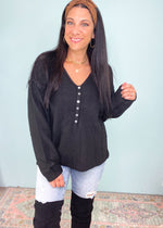 Black Henley Button Down Soft Sweater-This oatmeal soft sweater is guaranteed to be one of your new fav Fall rotation sweaters! It features the softest fabric with stretch to be worn tucked in, out or knotted. The functional henley buttons can be worn buttoned or unbuttoned for different looks from day to night. Also looks cute off the shoulder! -Cali Moon Boutique, Plainville Connecticut