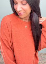 Pumpkin Spice Textured Relaxed Sweatshirt-This black soft sweater is guaranteed to be one of your new fav Fall rotation sweaters! It features the softest fabric with stretch to be worn tucked in, out or knotted. The functional henley buttons can be worn buttoned or unbuttoned for different looks from day to night. Also looks cute off the shoulder! -Cali Moon Boutique, Plainville Connecticut