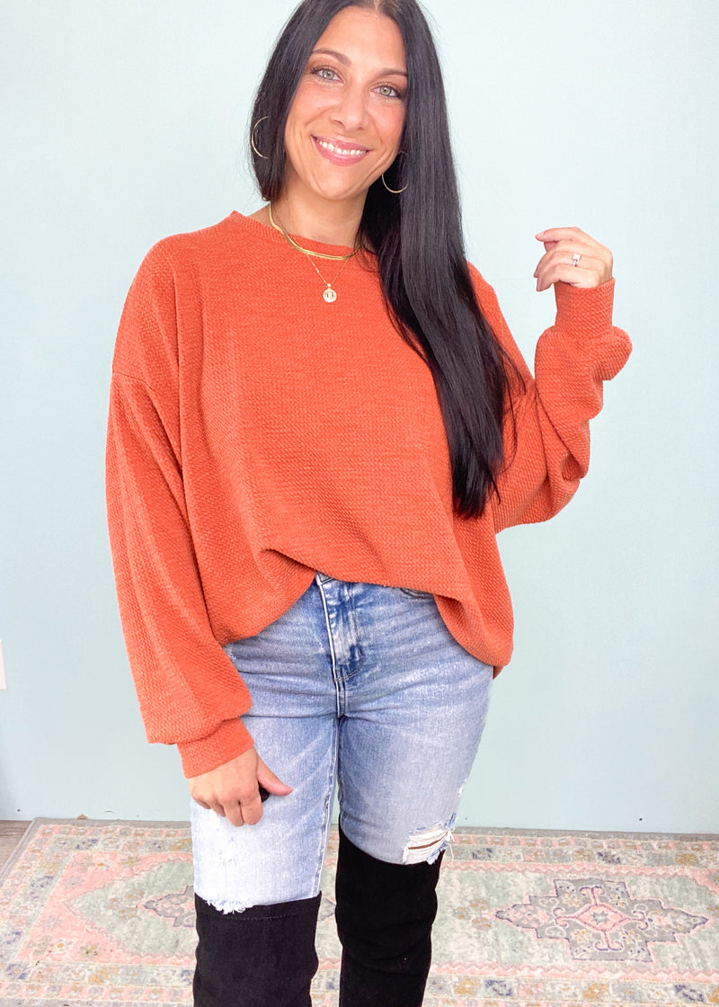 Pumpkin Spice Textured Relaxed Sweatshirt-This black soft sweater is guaranteed to be one of your new fav Fall rotation sweaters! It features the softest fabric with stretch to be worn tucked in, out or knotted. The functional henley buttons can be worn buttoned or unbuttoned for different looks from day to night. Also looks cute off the shoulder! -Cali Moon Boutique, Plainville Connecticut