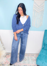 'On a Cloud' Denim Blue Ultra Soft Chenille Button Front Cardigan-This soft as a cloud cardigan in a beautiful denim blue features slouchy, front pockets and a draped look for a casual chic look every time. You will be able to mix &amp; match for so many in or out of the office looks. Wear it slightly off the shoulder, buttoned or unbuttoned for all your different outfits.-Cali Moon Boutique, Plainville Connecticut