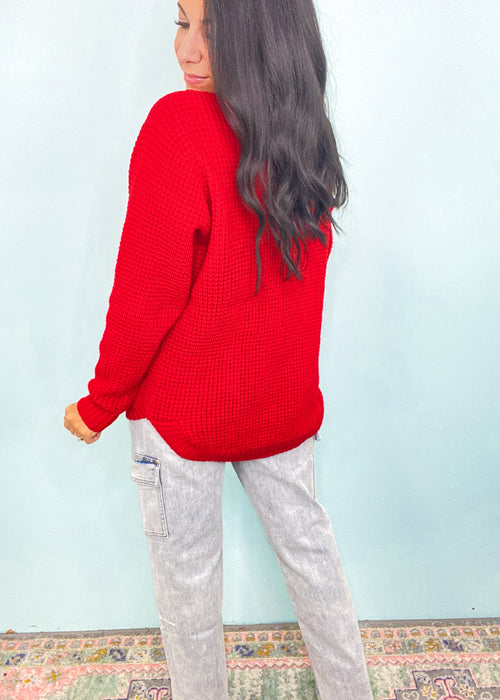 **DOORBUSTER** Ruby Red Waffle Round Neck Sweater-This waffle knit sweater is a must have classic silhouette! The split hem makes it easy to tuck in but also looks cute untucked with the rounded bottom hem. Dress this sweater up with skirts or jeans and boots and layered jewelry or you can wear it super casual with jeans and sneakers. -Cali Moon Boutique, Plainville Connecticut