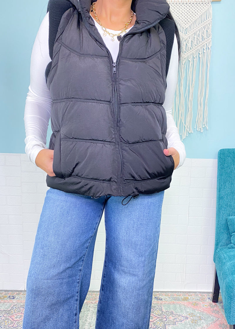 'After Dusk' Black Puffer Vest With Hood-The knit ribbed cap shoulder detail sets this black puffer vest apart from all the others! A soft nylon puffer style with a hood that can be retracted. A Fall/Winter must have!-Cali Moon Boutique, Plainville Connecticut