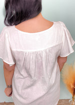 'Faith' Off White Square Neck Flutter Sleeve Top-Feel the warm island breeze when we look at this lightweight flowy top! The gauze like fabric is perfect for Spring & Summer. The flutter sleeves add a feminine touch. A super easy-to-style top that can be tucked in for an effortless look.-Cali Moon Boutique, Plainville Connecticut