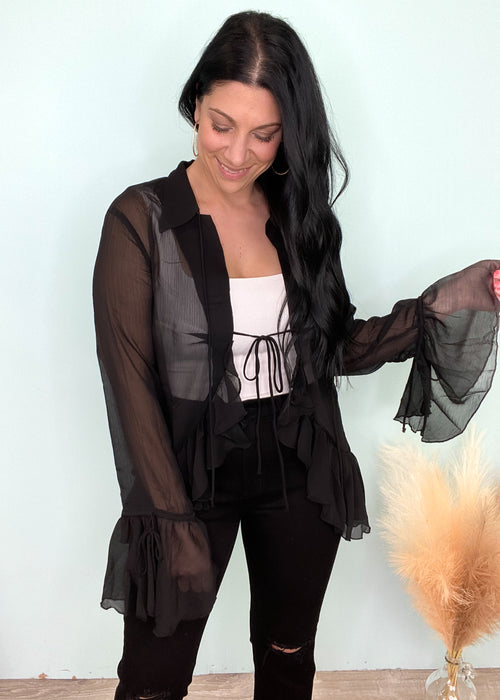 'With the Band' Black Sheer Ruffle Tie Front Blouse-This sheer ruffle bell sleeve top is giving us all the Boho western glam vibes! She is ready for a night out to dinner with the girls, Summer concerts and vacation nights out! Pair with a printed/embellished top underneath or keep it simple with a solid pop color! Looks great with wide leg denim or your favorite distressed denim shorts! -Cali Moon Boutique, Plainville Connecticut