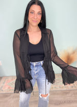 'With the Band' Black Sheer Ruffle Tie Front Blouse-This sheer ruffle bell sleeve top is giving us all the Boho western glam vibes! She is ready for a night out to dinner with the girls, Summer concerts and vacation nights out! Pair with a printed/embellished top underneath or keep it simple with a solid pop color! Looks great with wide leg denim or your favorite distressed denim shorts! -Cali Moon Boutique, Plainville Connecticut